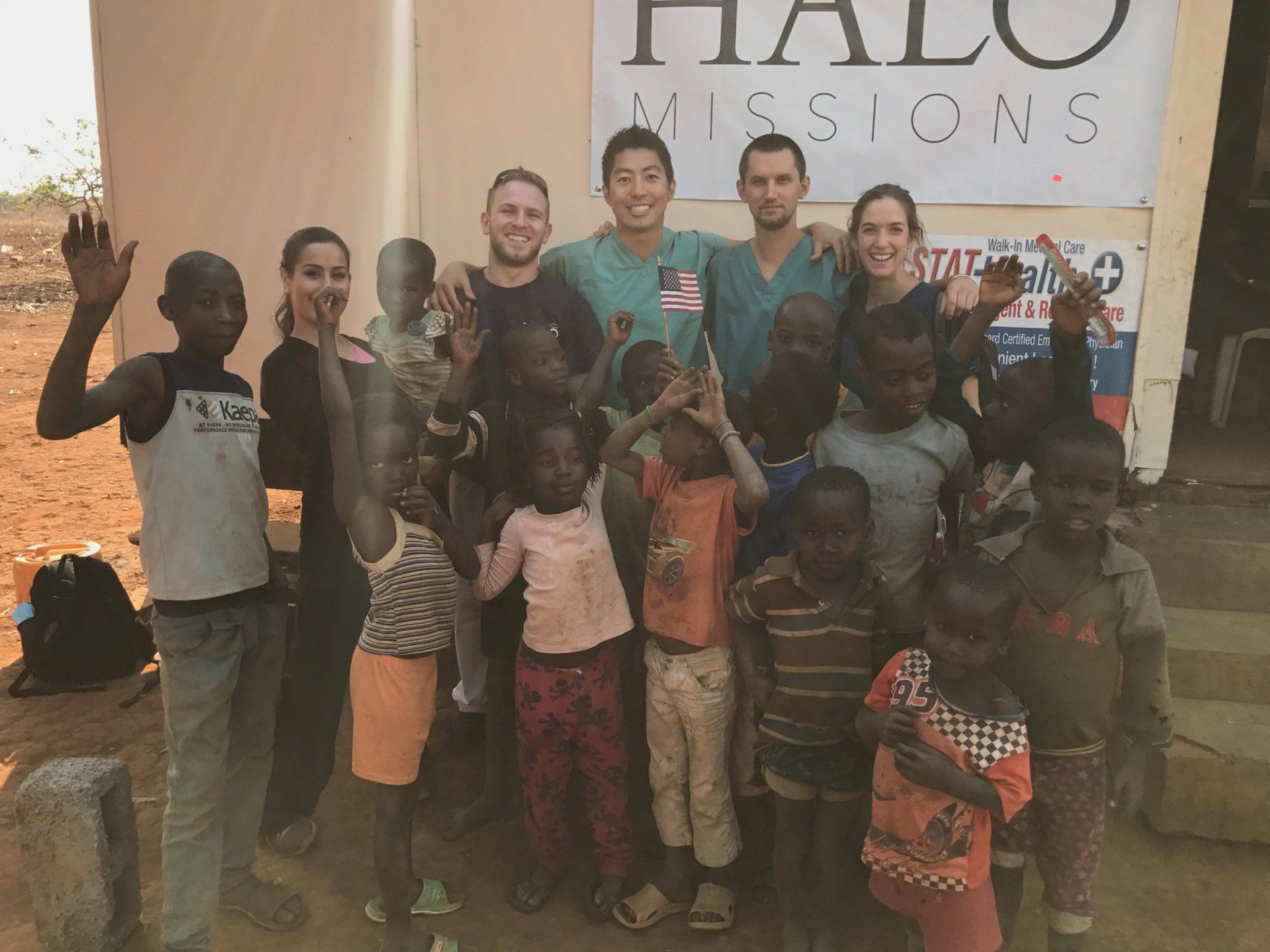 A group of people standing in front of a sign that says halo missions