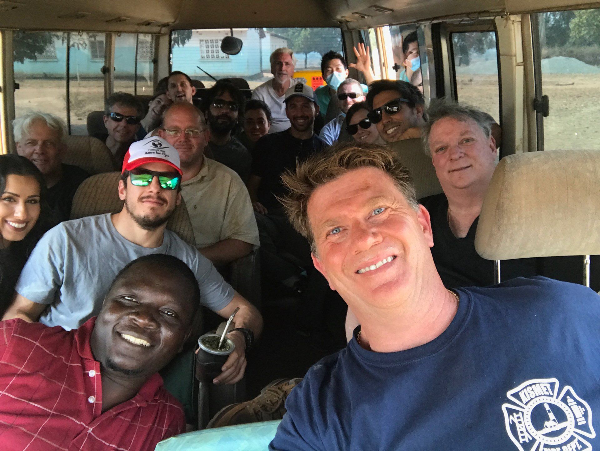 A group of people are posing for a picture on a bus