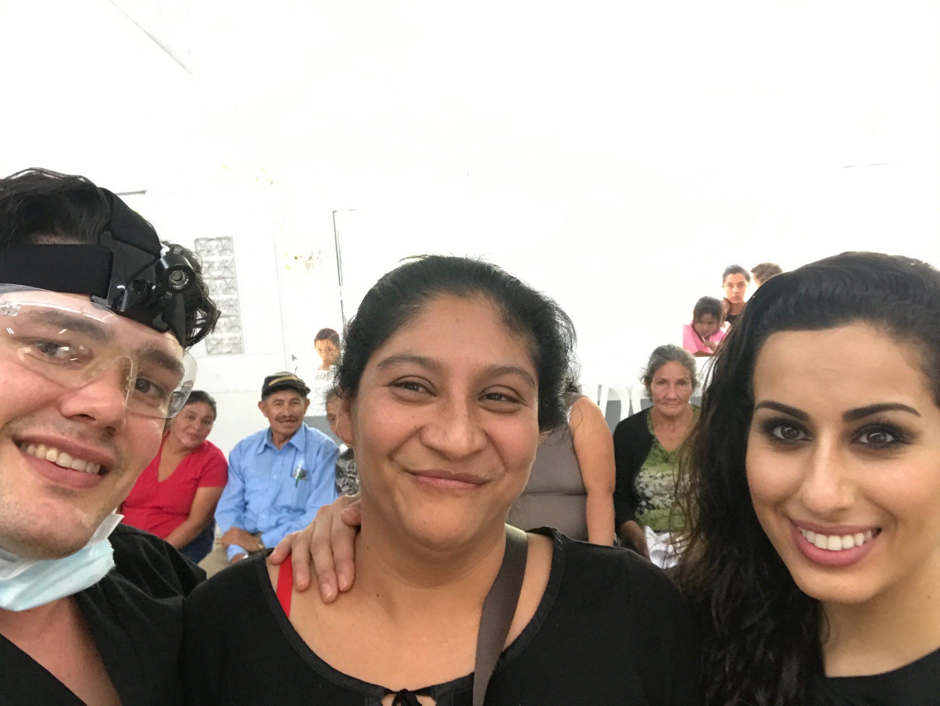 A group of people are posing for a picture and smiling