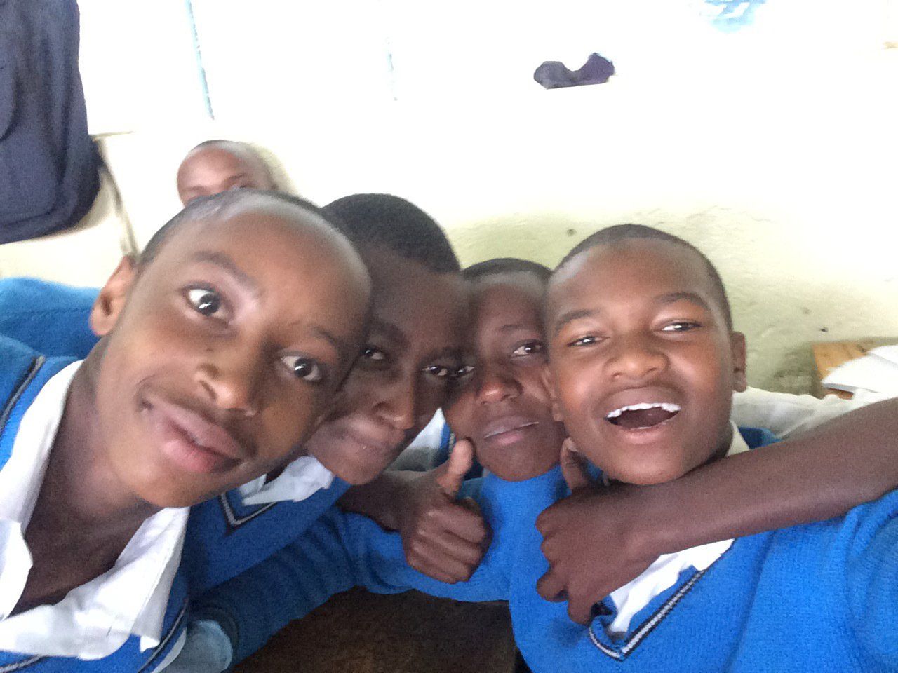 A group of young boys are posing for a picture together