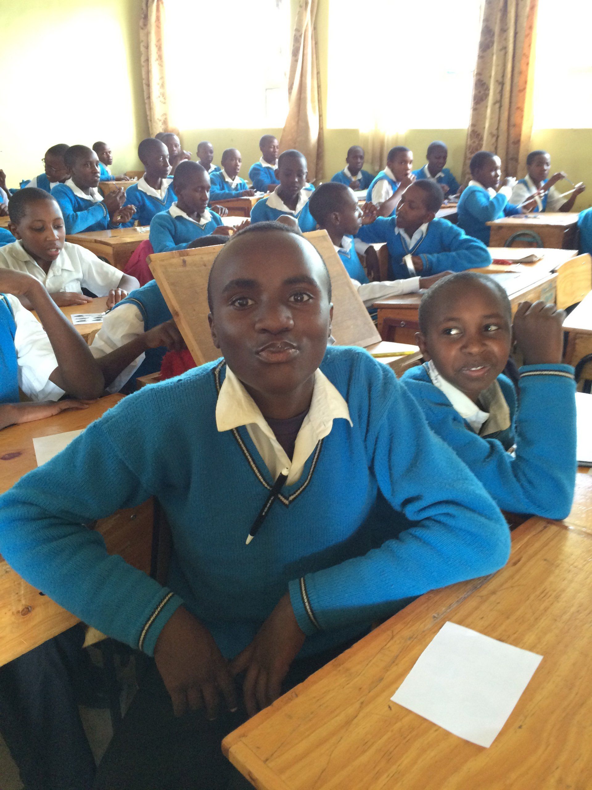 A group of children are sitting at their desks in a classroom