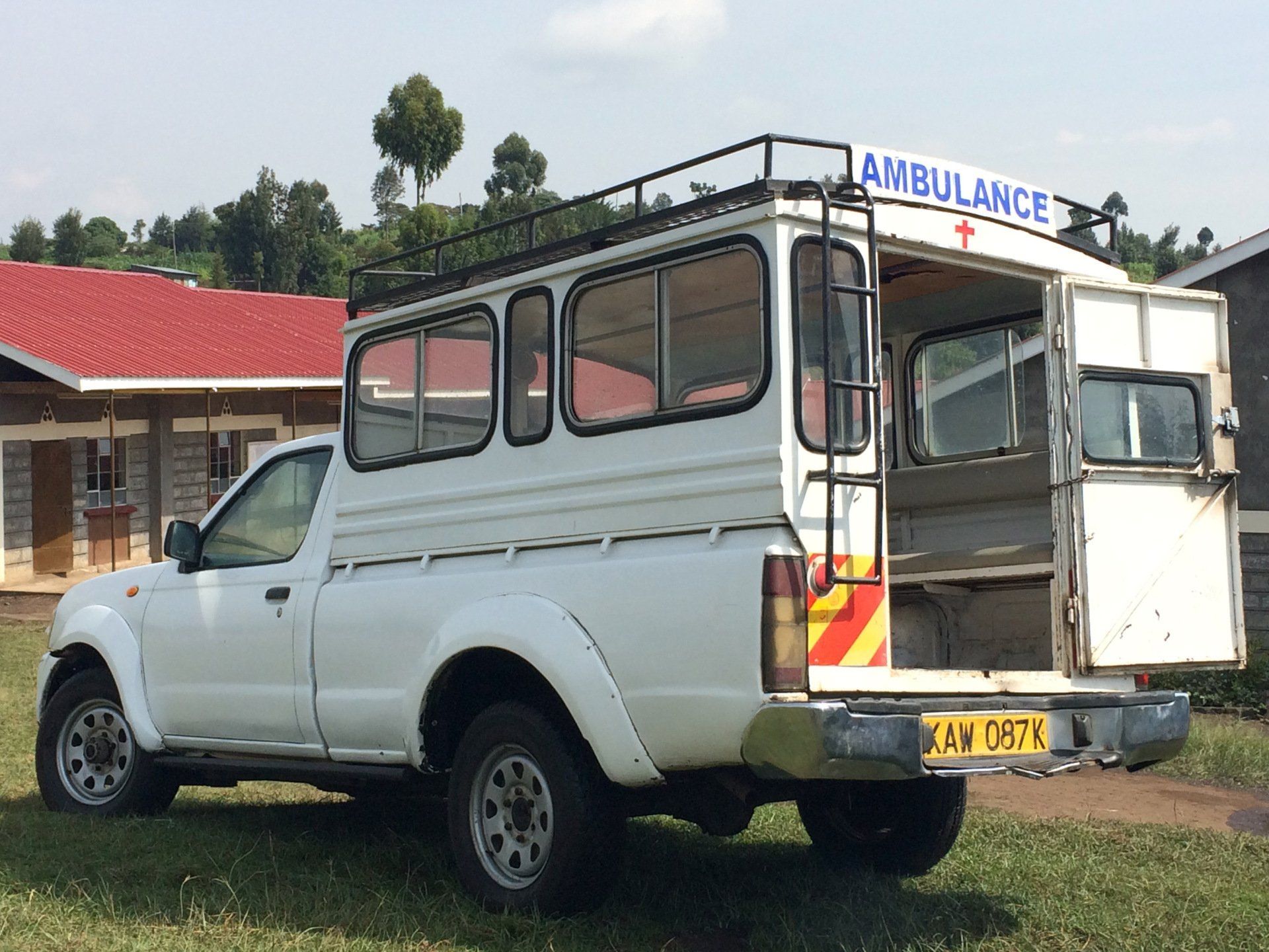 A white truck with an ambulance on top of it