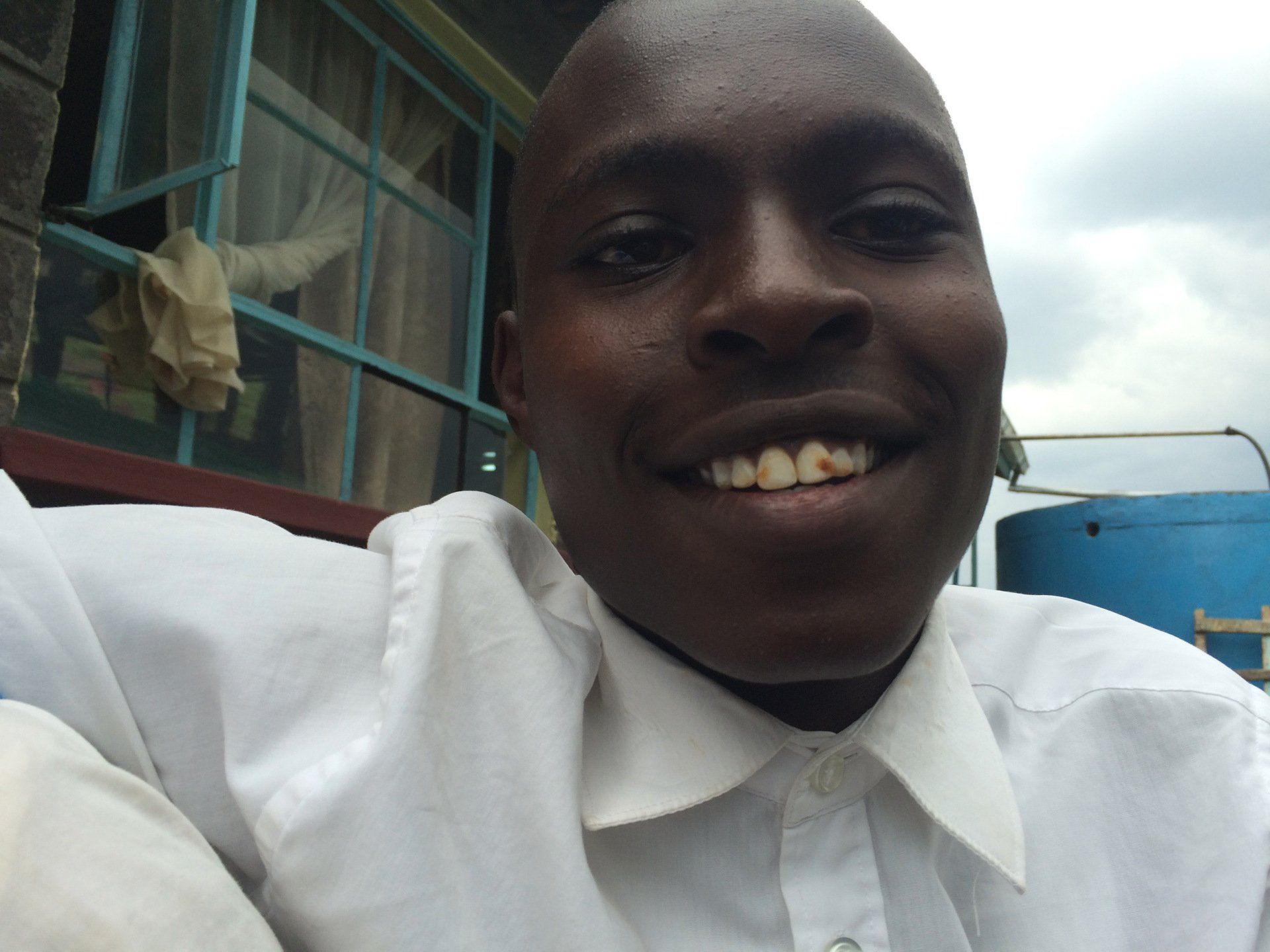 A man in a white shirt is smiling for the camera