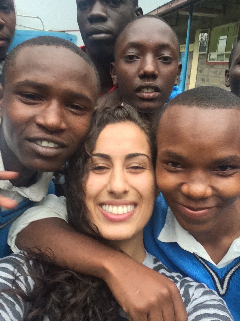 A group of people posing for a picture with a woman in the middle