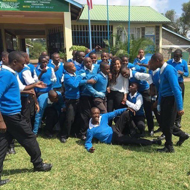 A group of people in blue sweaters are posing for a picture