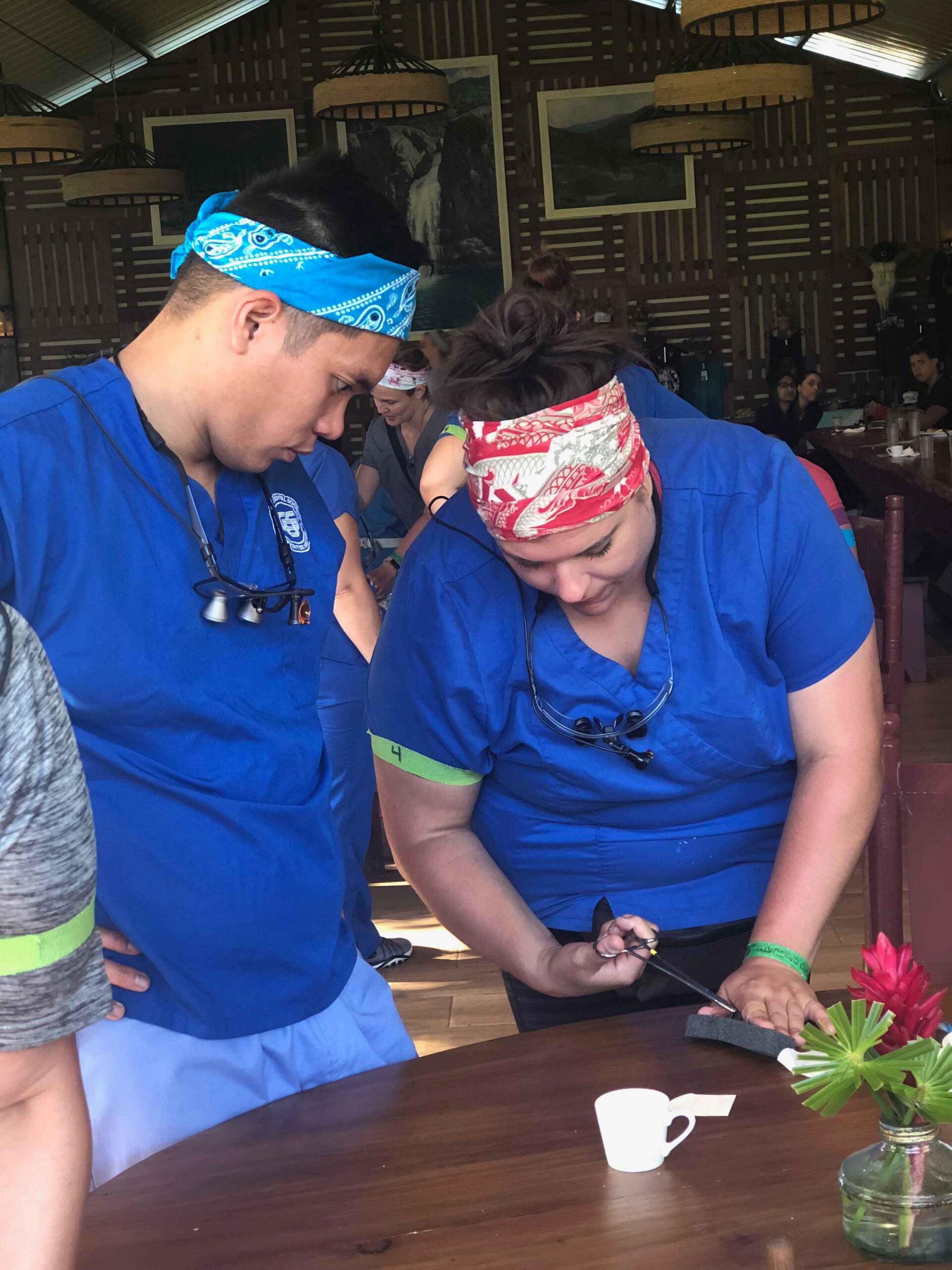 A man and a woman are sitting at a table looking at something