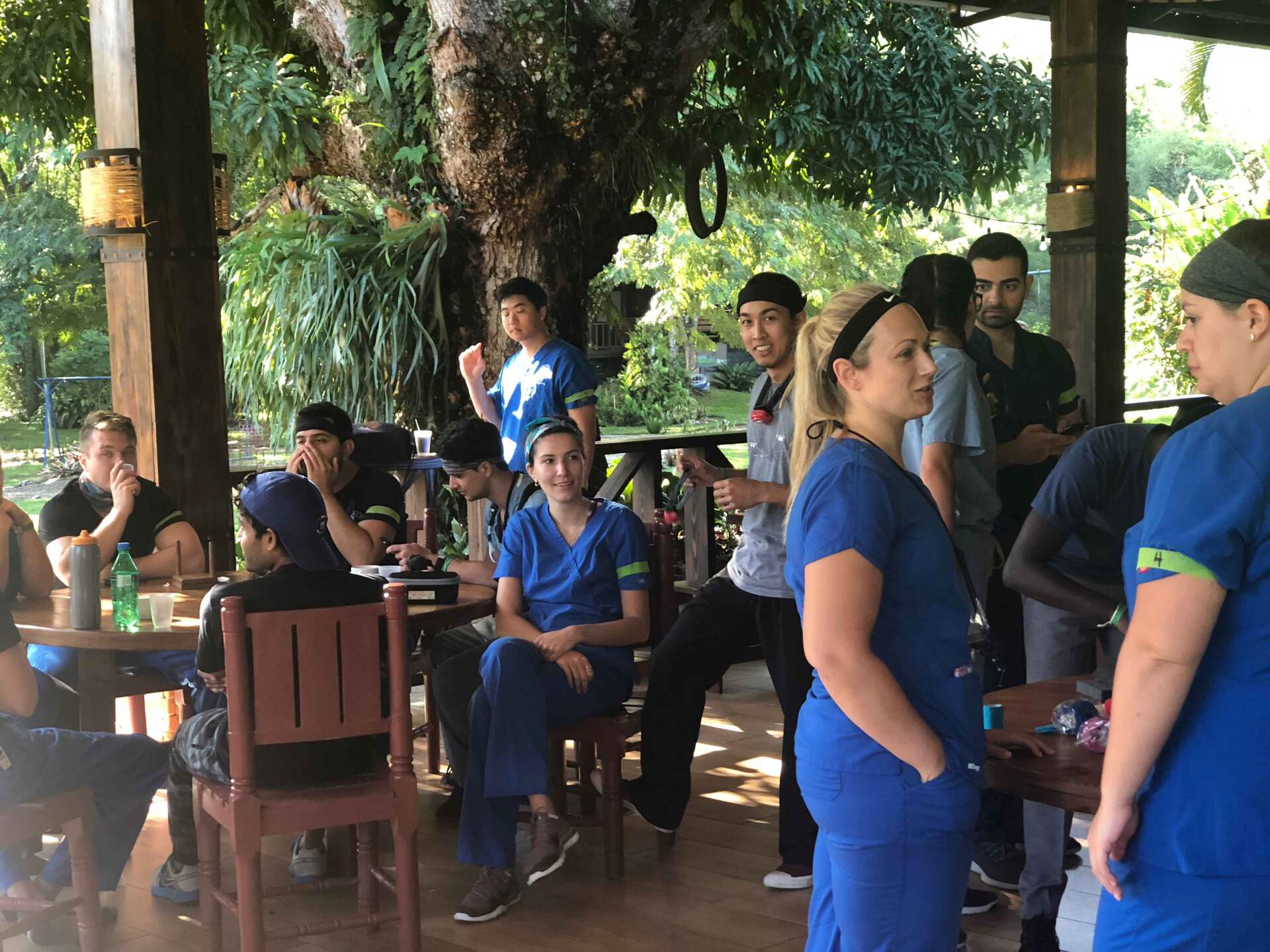 A group of people in scrubs are standing around a table.