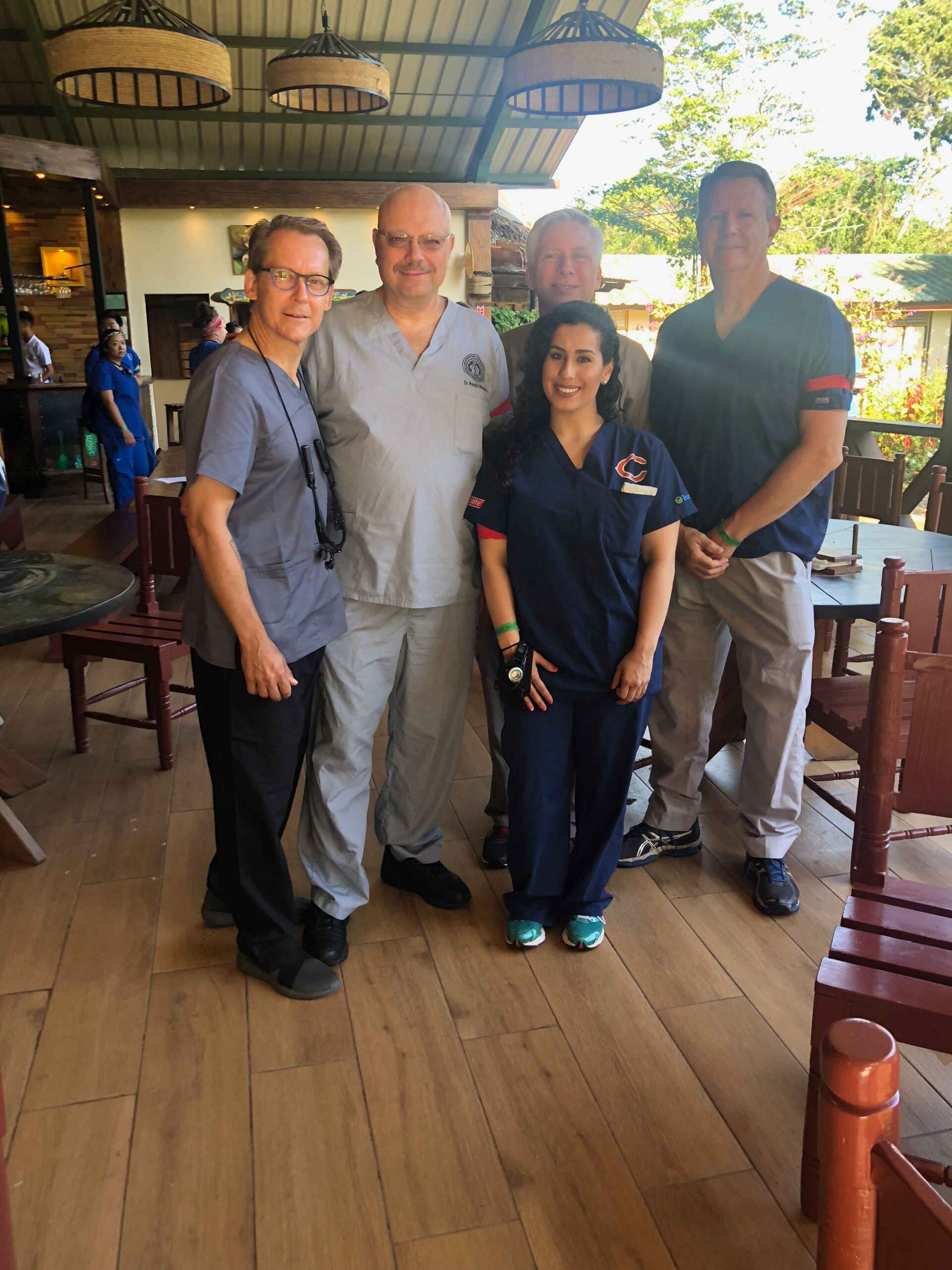A group of people in scrubs are posing for a picture.