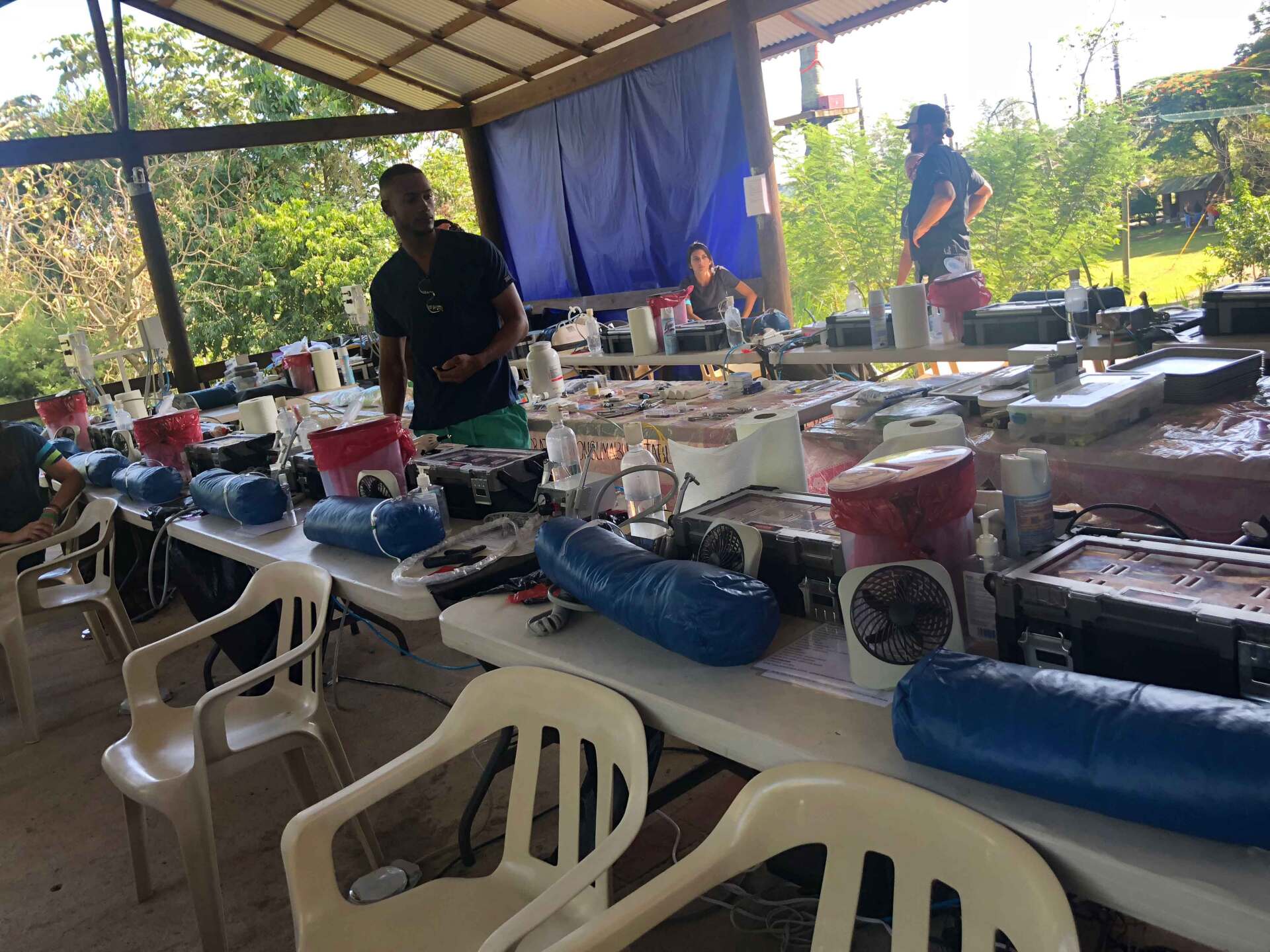 A man is standing in front of a table with a lot of food on it.