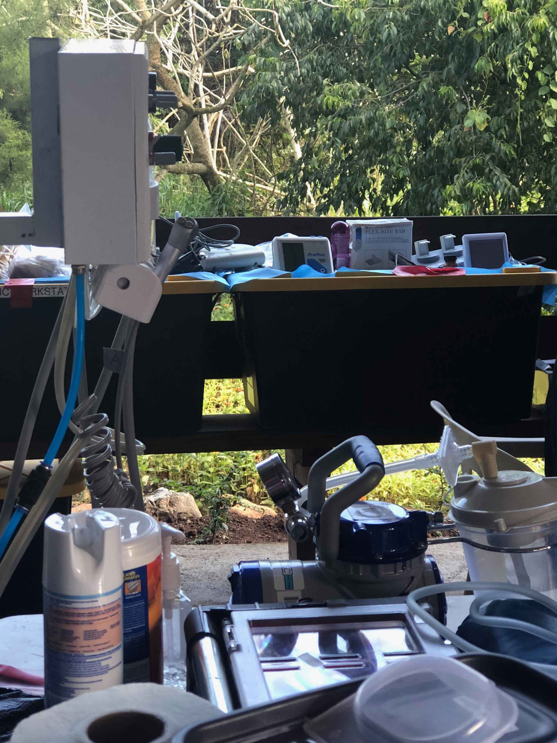 A bottle of spray paint sits on a table in front of a window