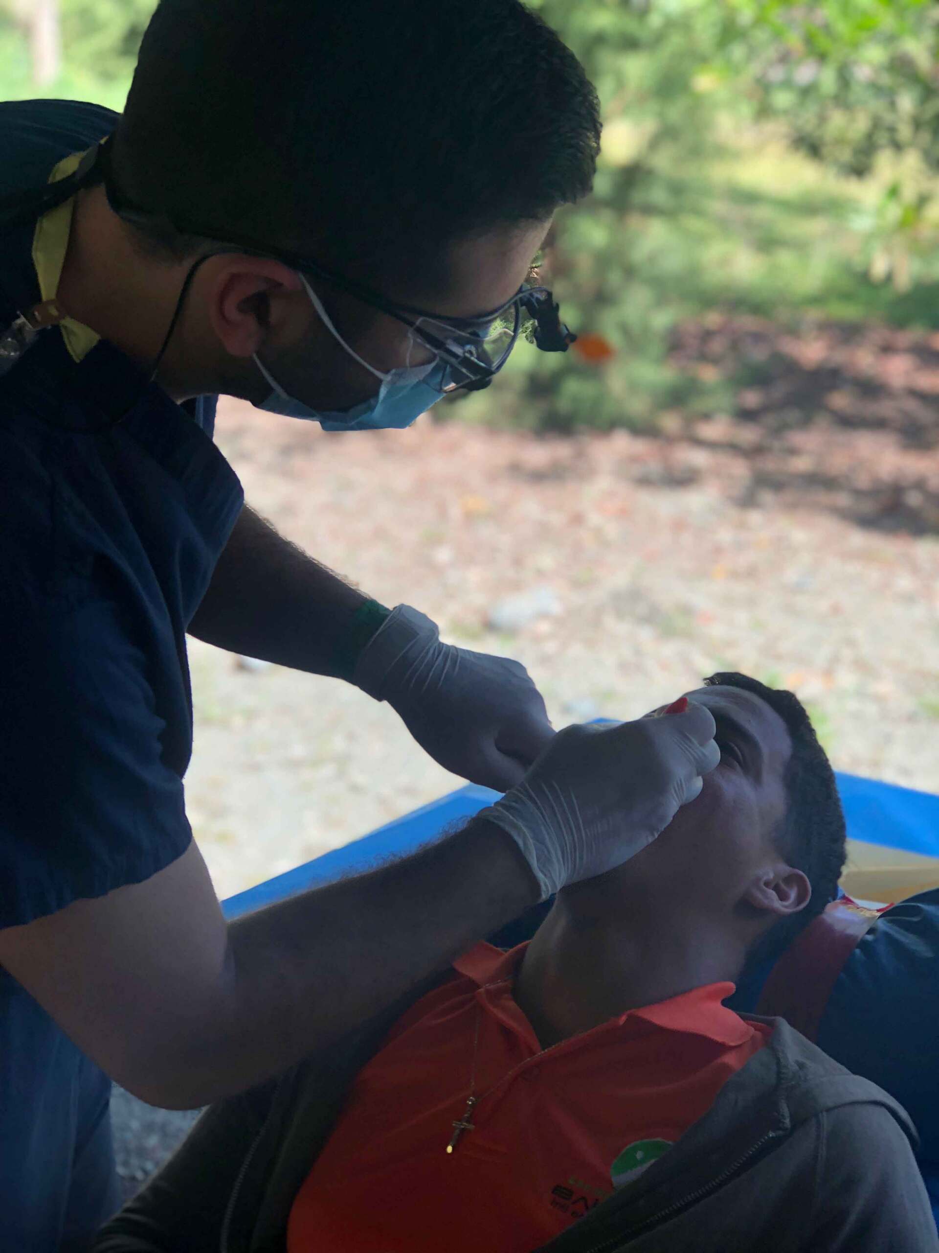 A man is getting his teeth examined by a dentist