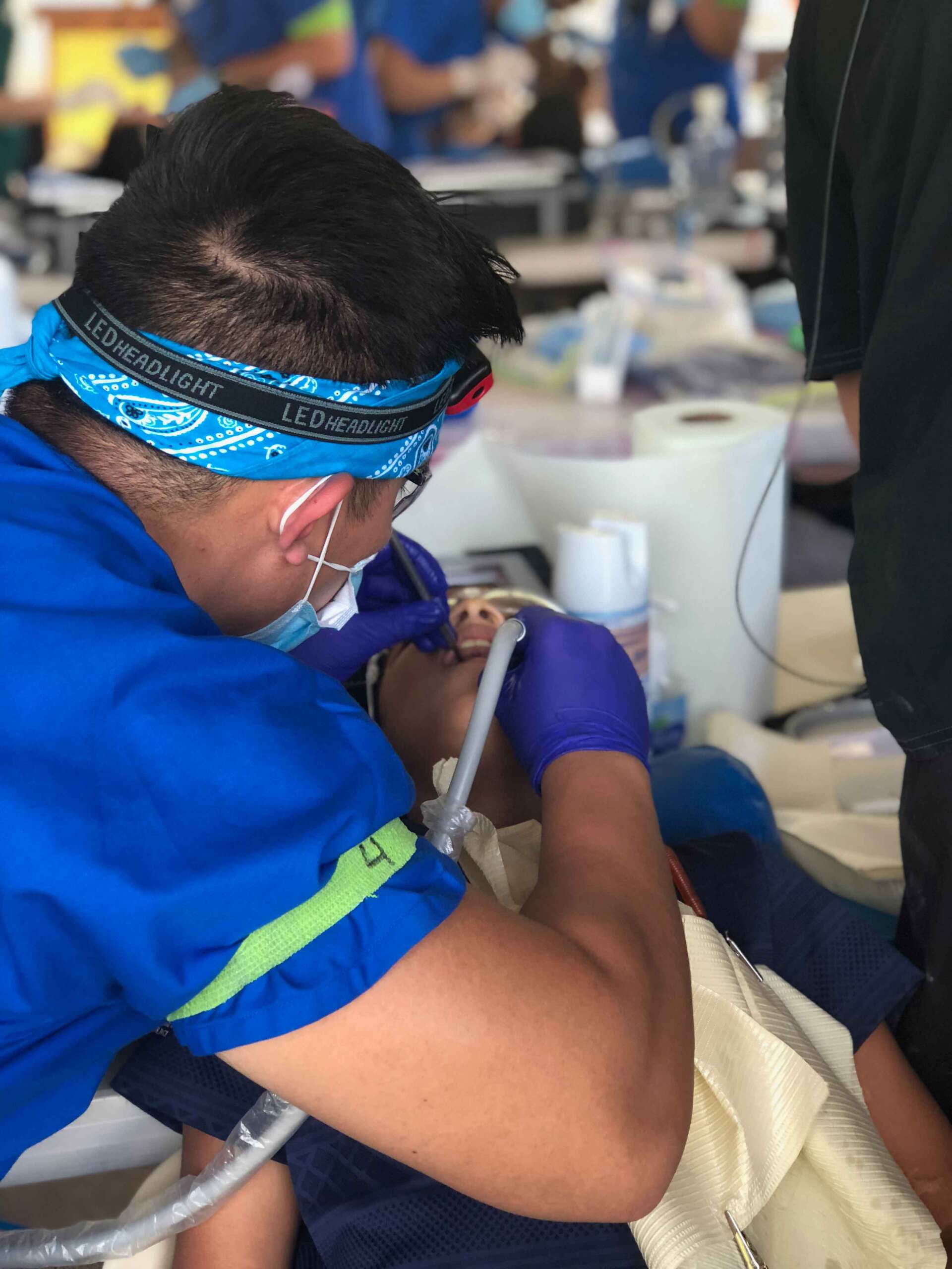 A dentist is working on a child 's teeth in a dental office.