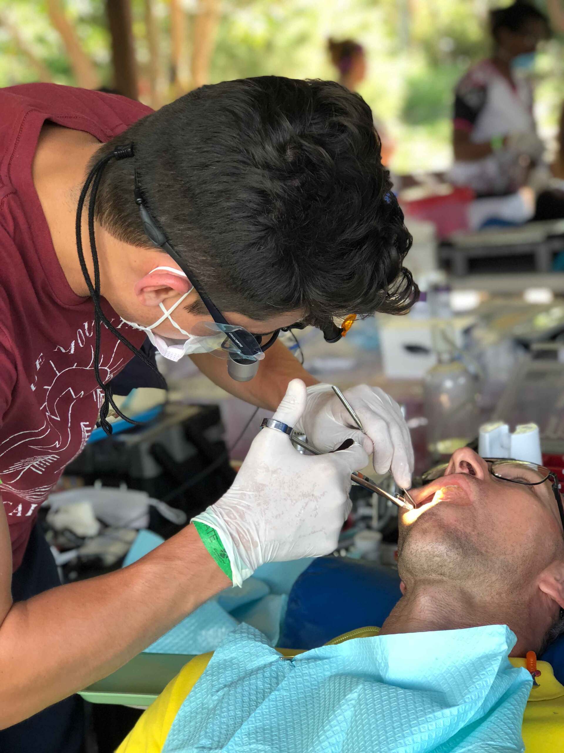 A man is getting his teeth examined by a dentist.