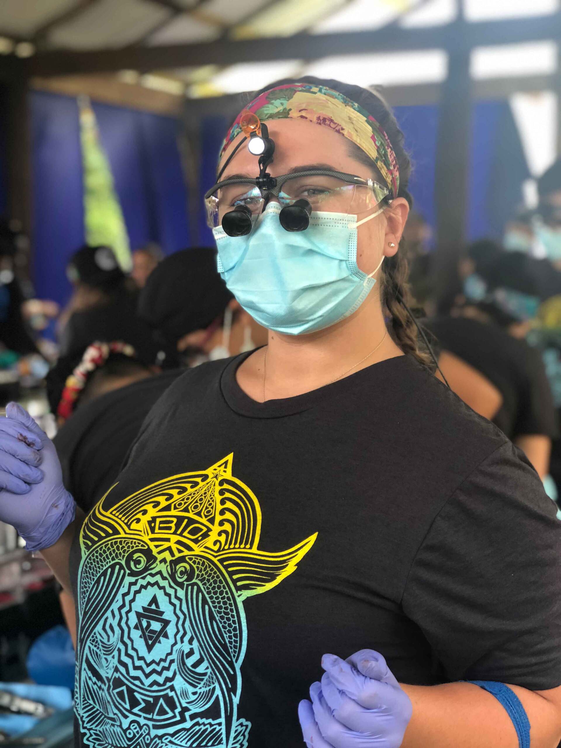 A woman wearing a mask and magnifying glasses