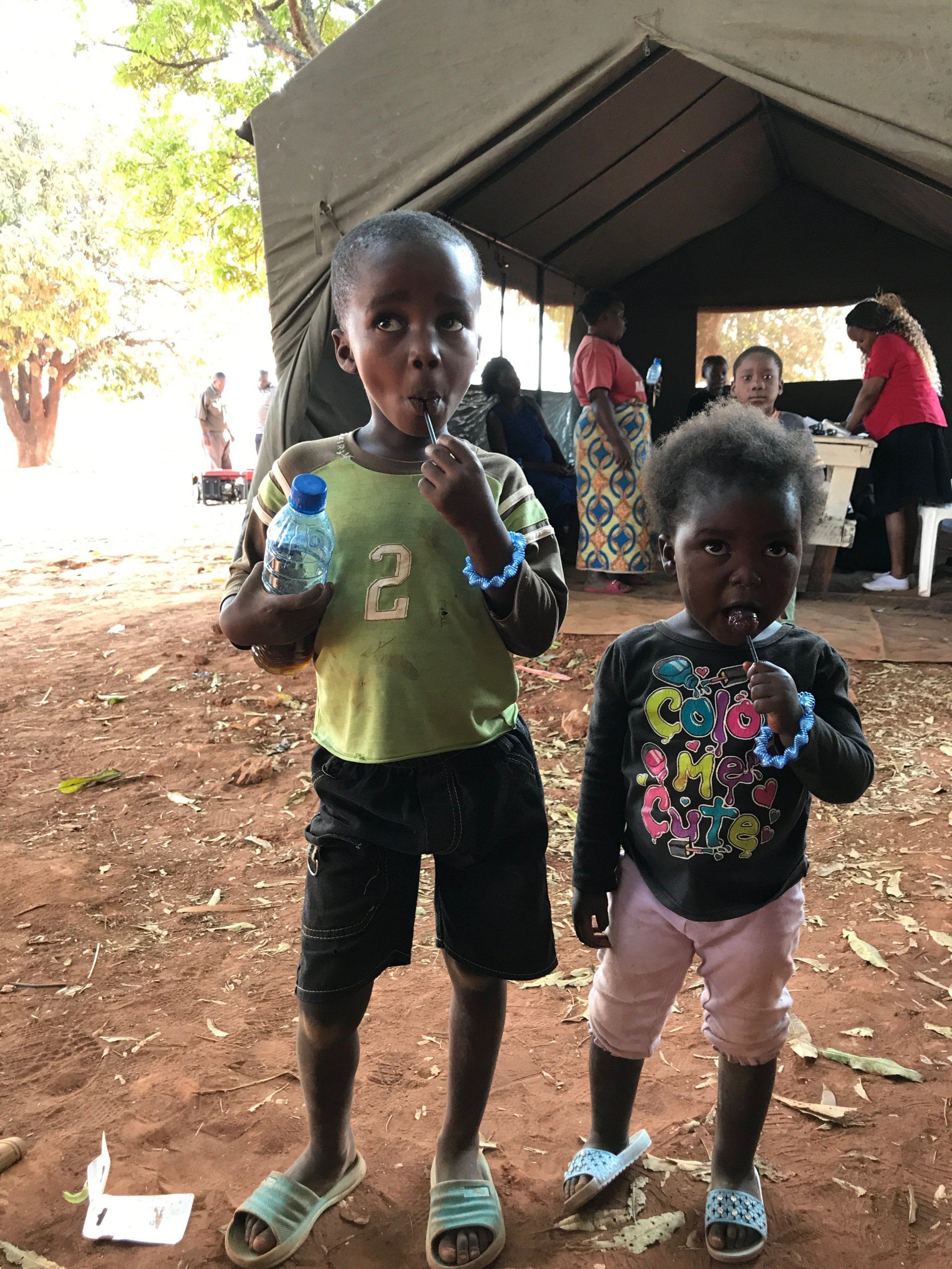 A boy with the number 2 on his shirt is standing next to a girl