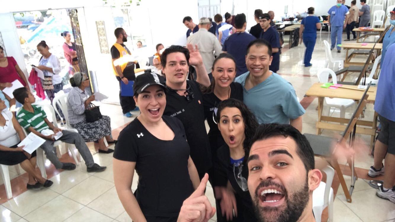 A group of people are posing for a picture in a crowded room.
