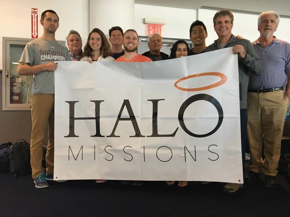 A group of people holding a banner that says halo missions