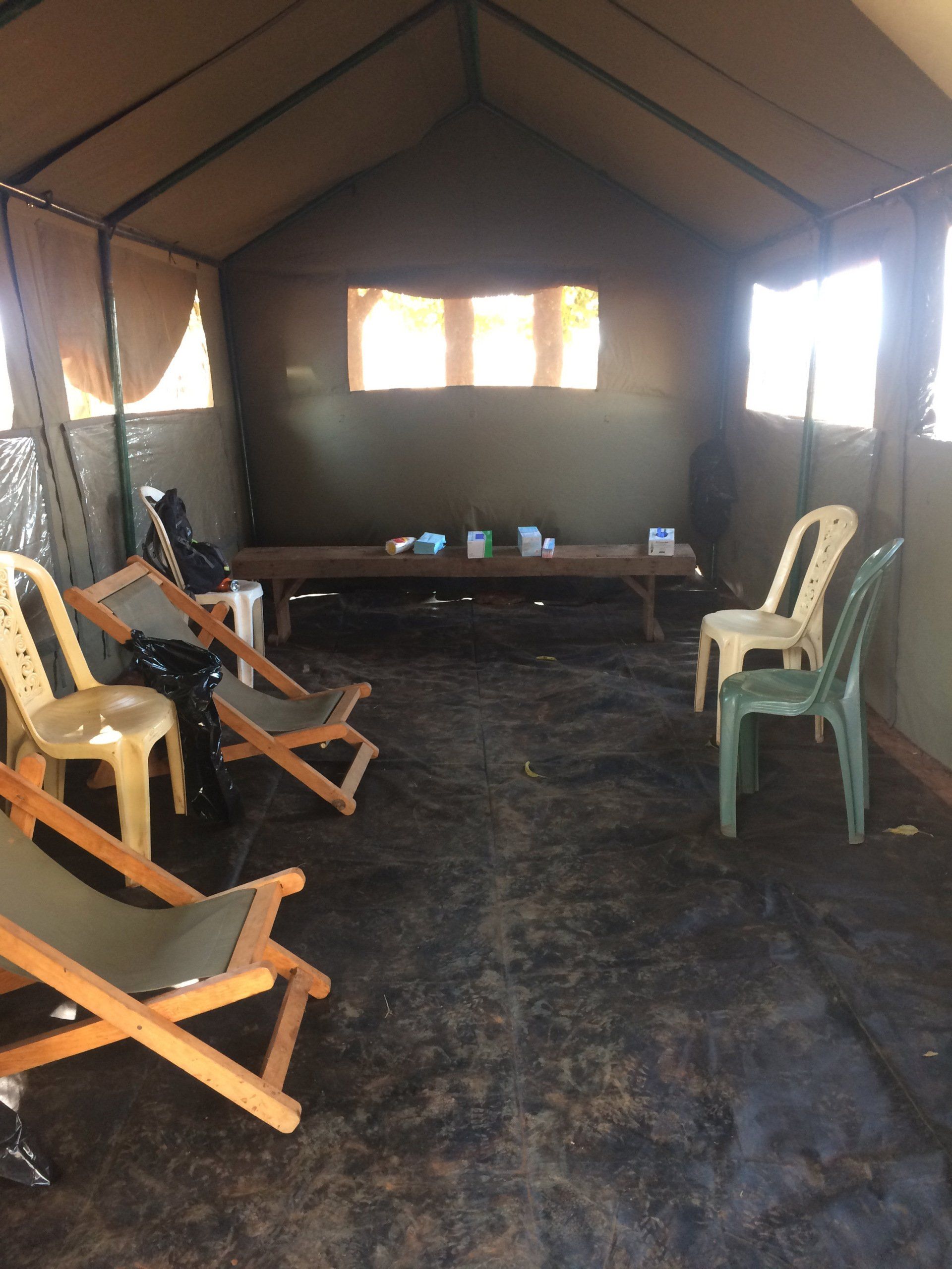 A tent with chairs and tables inside of it