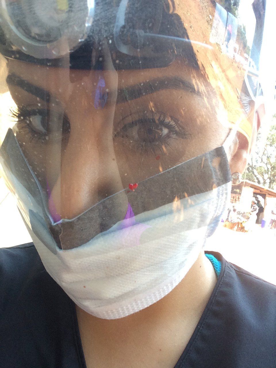 A close up of a woman wearing a mask and goggles