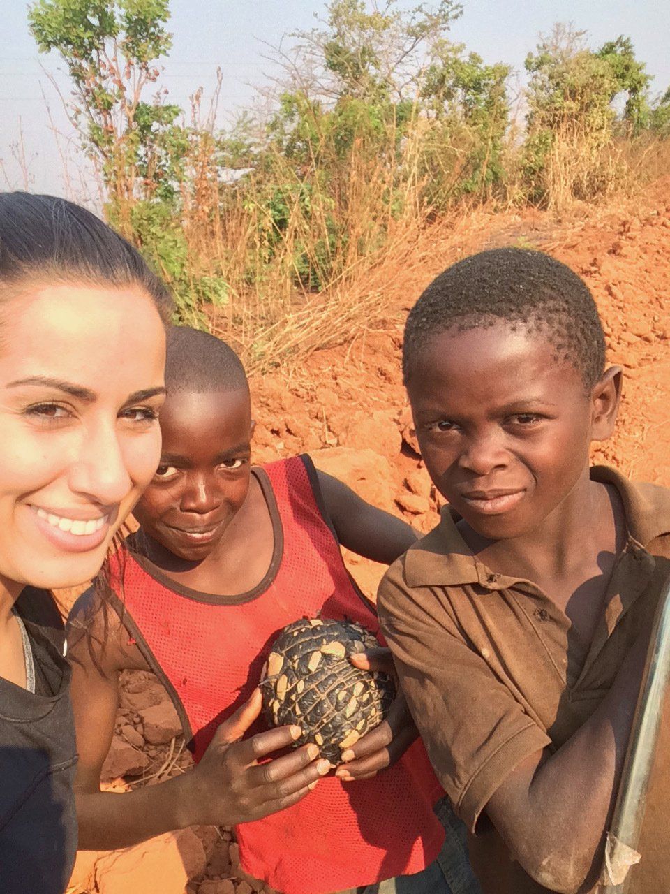 A woman is posing for a picture with two young boys