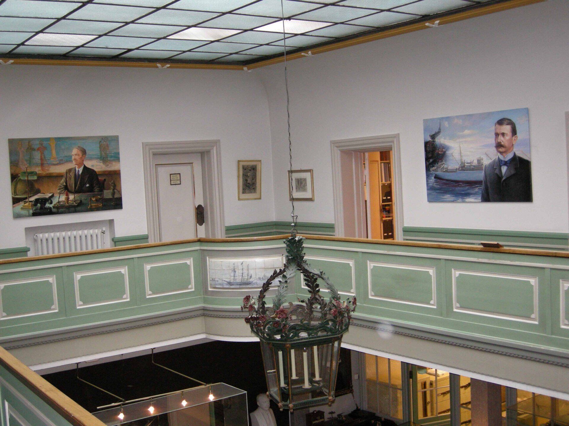 Interior view of Olsen offices with portraits by Mariusz Kaldowski displayed on walls
