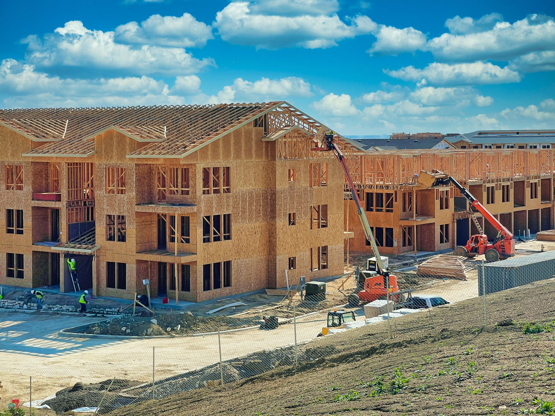 Multi-family apartment building under construction with wood framing and roof trusses