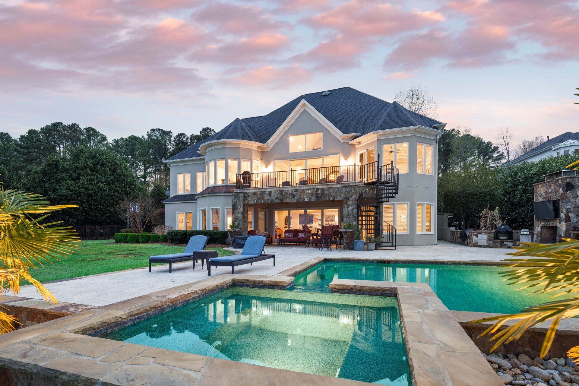 A large house with a large swimming pool in front of it.
