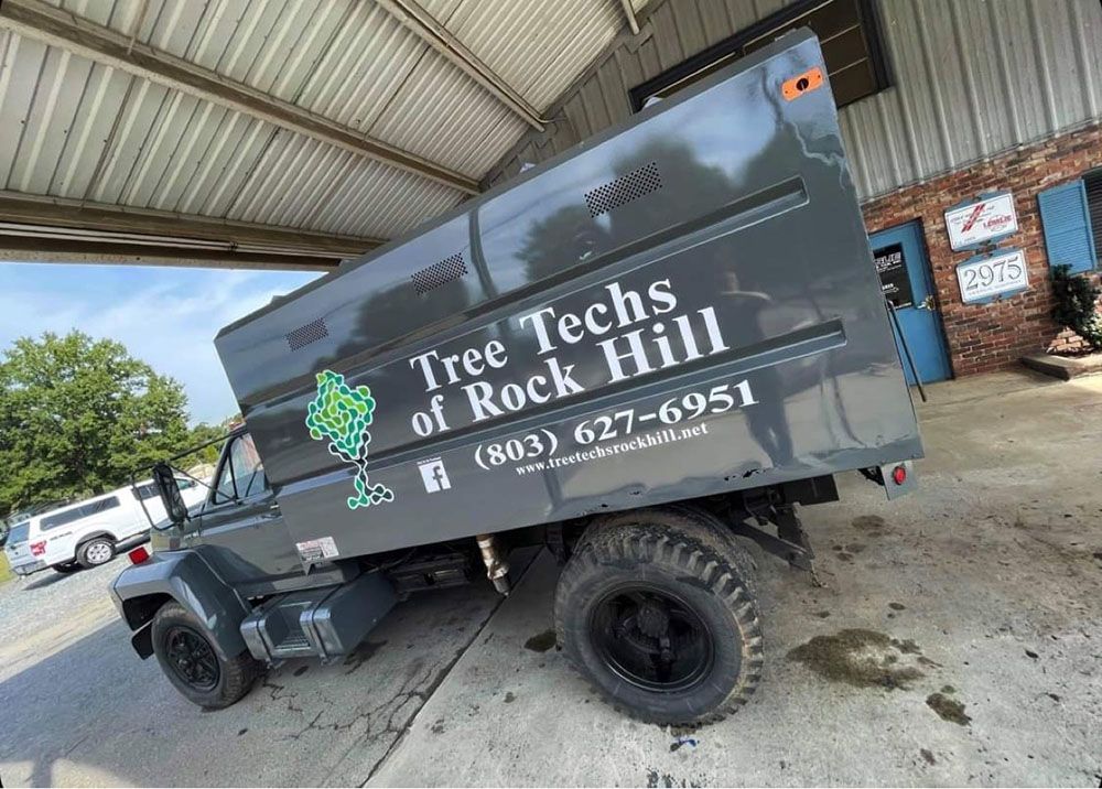 A dark gray dump truck branded 