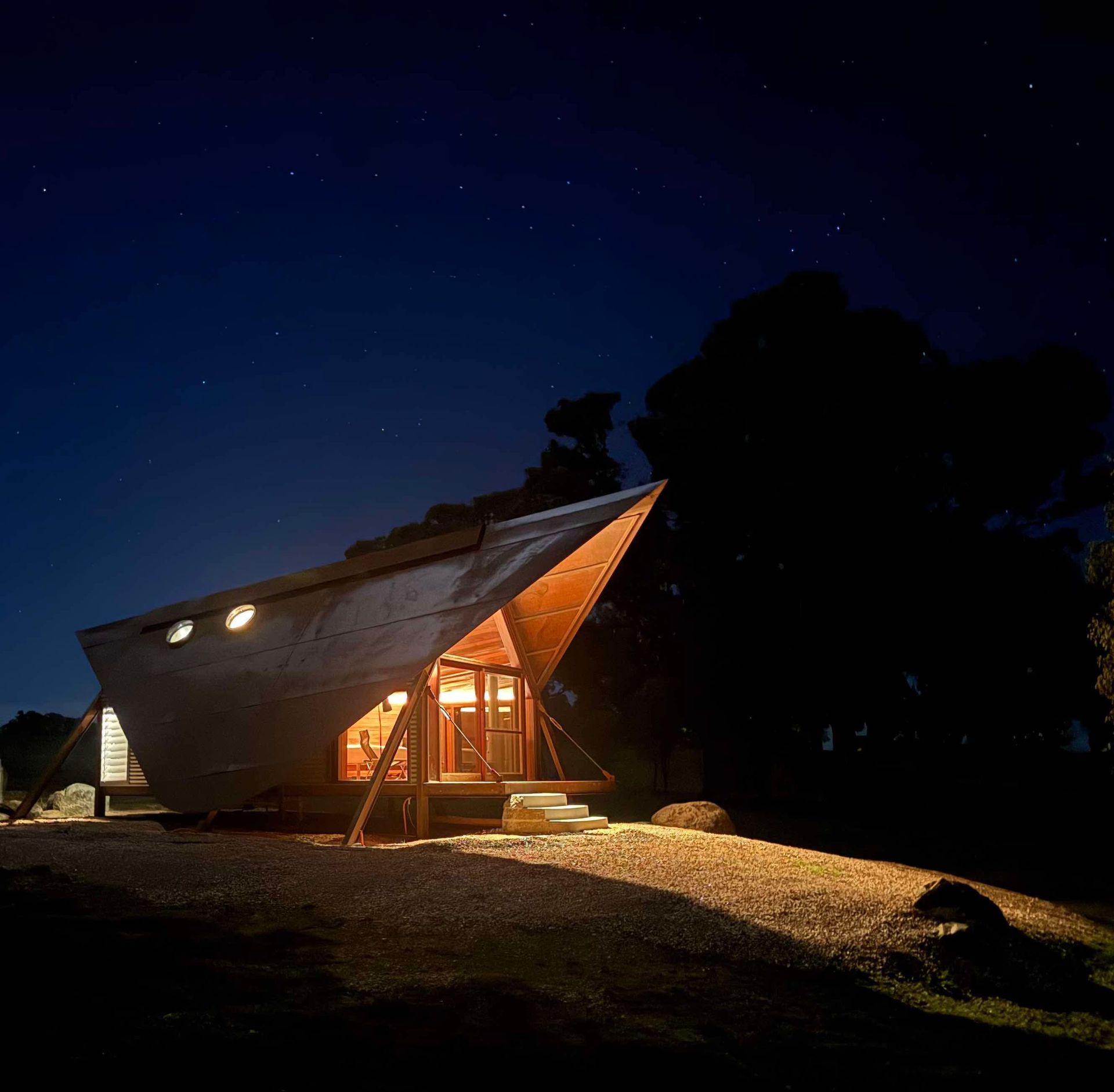 Wooden cabin illuminated at night — SJD Electrical Contracting in Forbes, NSW