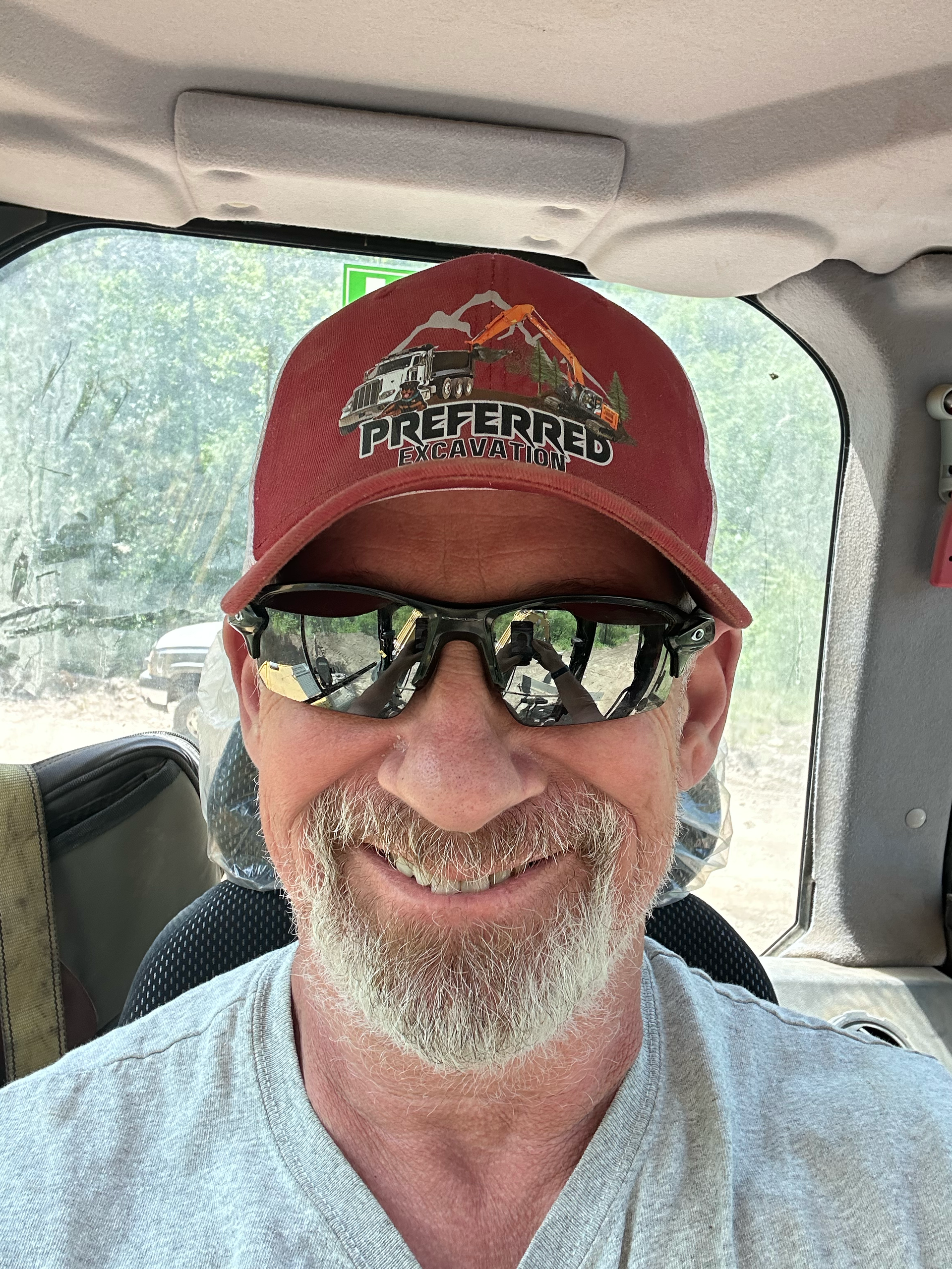 Photo of Dan Smith, owner of Preferred Excavation wearing sunglasses and a red cap with a logo.