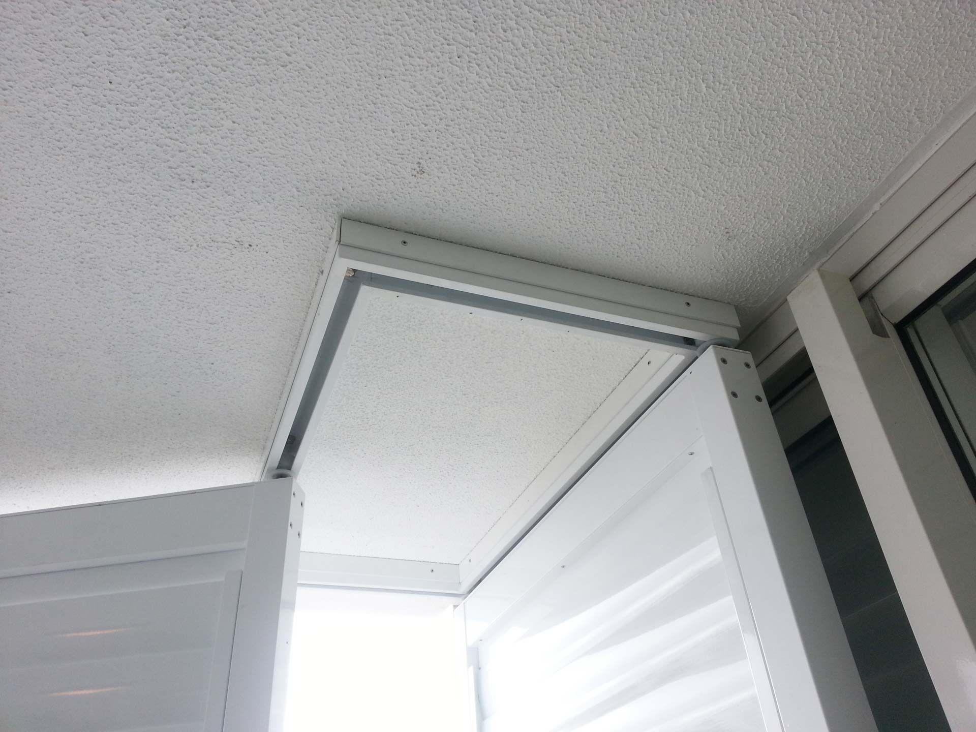 A White Door Is Open To A Balcony With A White Ceiling — Balcony Shutters Australia In Moffat Beach, QLD
