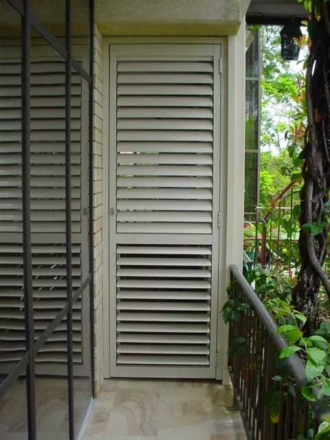 A Door With Shutters On It Is Open To A Balcony — Balcony Shutters Australia In Moffat Beach, QLD