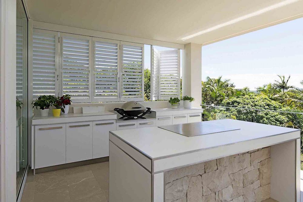 There Is A Large Island In The Middle Of The Kitchen — Balcony Shutters Australia In Brisbane, QLD