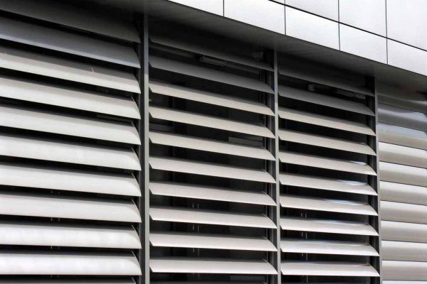 A Building With A Lot Of Shutters On It — Balcony Shutters Australia In Moffat Beach, QLD