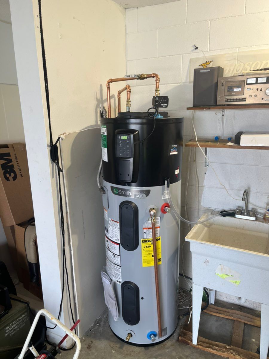 Water heater tank in a utility room next to a sink and shelving.
