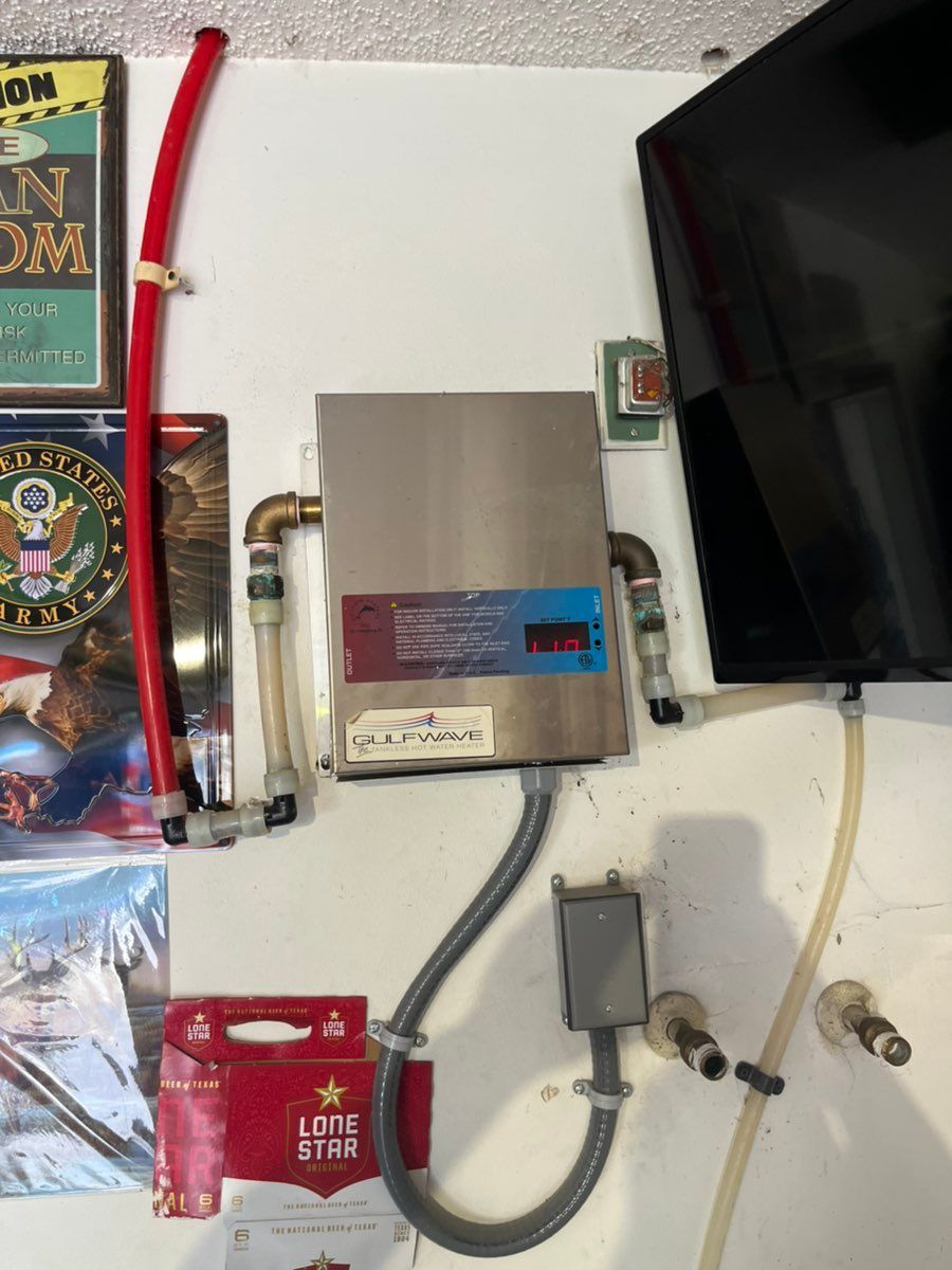 Wall-mounted utility panel with meter box, red cable, gray conduits, and part of a TV on the right.