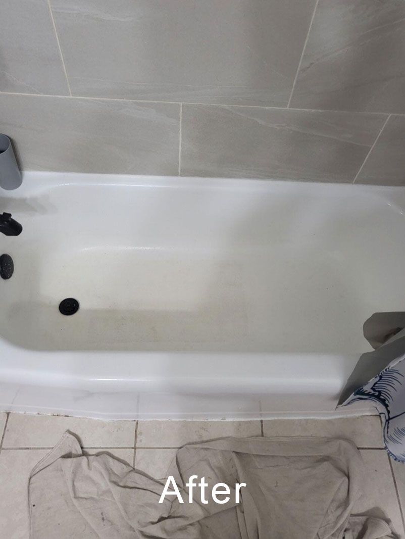 Empty white bathtub with black debris spots and the word “After” overlaid on the bottom.