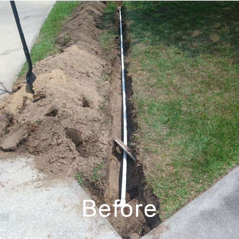 Before: sidewalk edge trench with exposed white pipe and dirt beside a grassy lawn