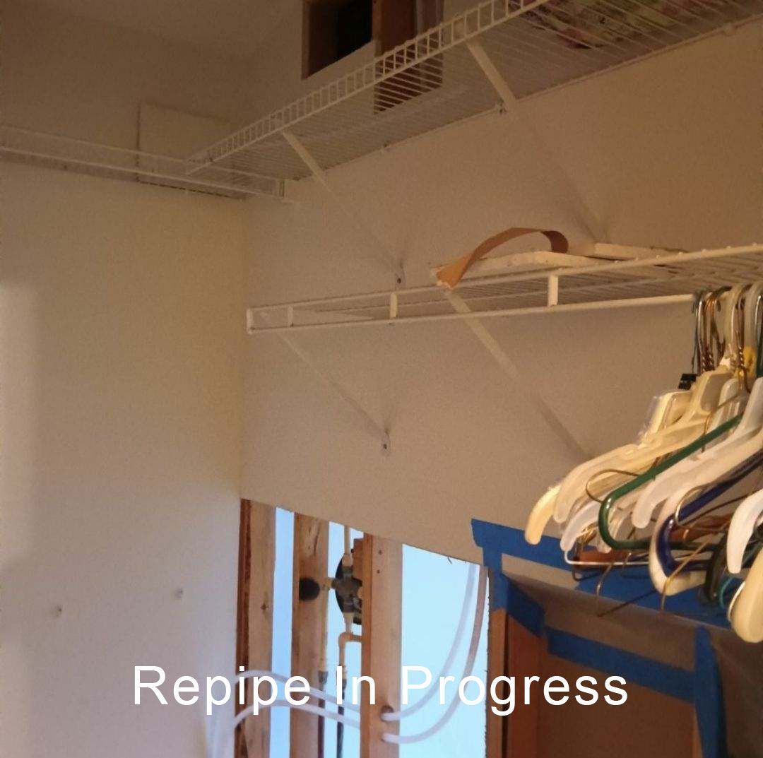 Empty walk-in closet with white wire shelves and hanging clothes; text reads “Repiping in Progress.”