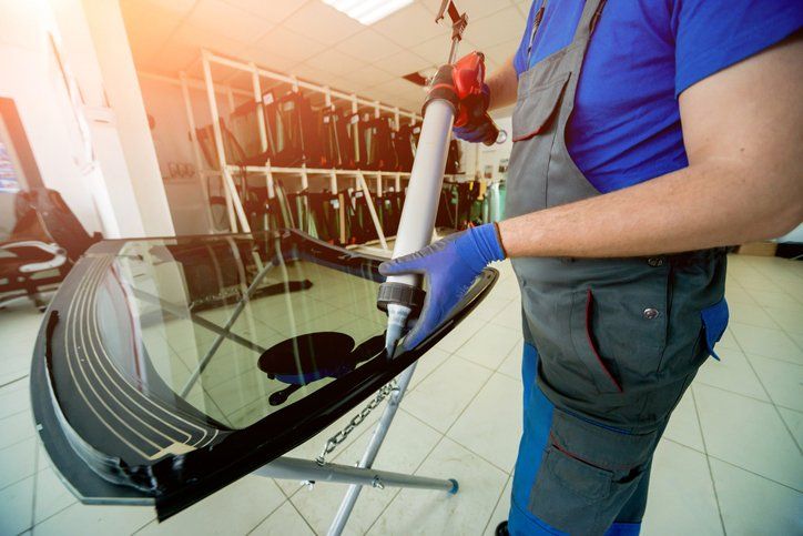 Automobile Worker Applying Glue To Windscreen – Coffs Harbour, NSW – City Autoglass Pty Ltd