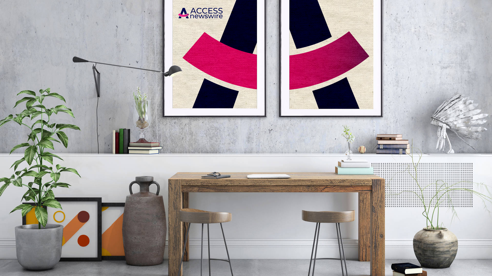 A room with a wooden desk and two posters on the wall