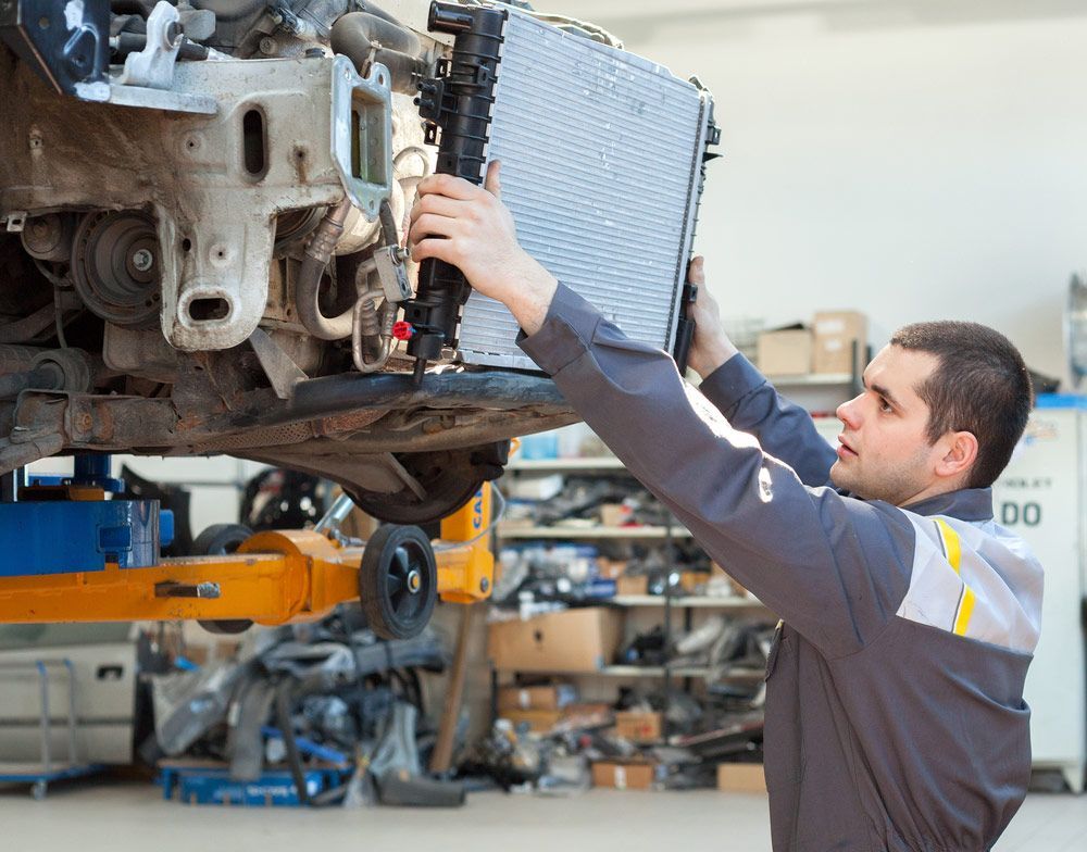 Car Mechanic Is Changing Radiator — Torque Masters Auto Repairs Centre In Portsmith QLD