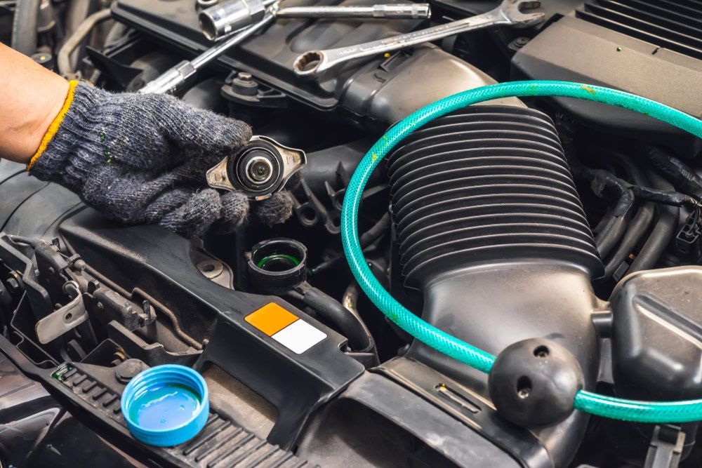 Hand Of Mechanic Check Water In Car Radiator And Add Water Antifreeze Coolant Fluid — Torque Masters Auto Repairs Centre In Portsmith QLD