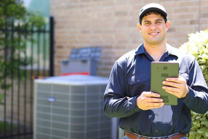 Air conditioner repairman working at residential home - Tallahassee, FL - Todd King's Heating and Cooling Air conditioner repairman working at residential home - Tallahassee, FL - Todd King's Heating and Cooling