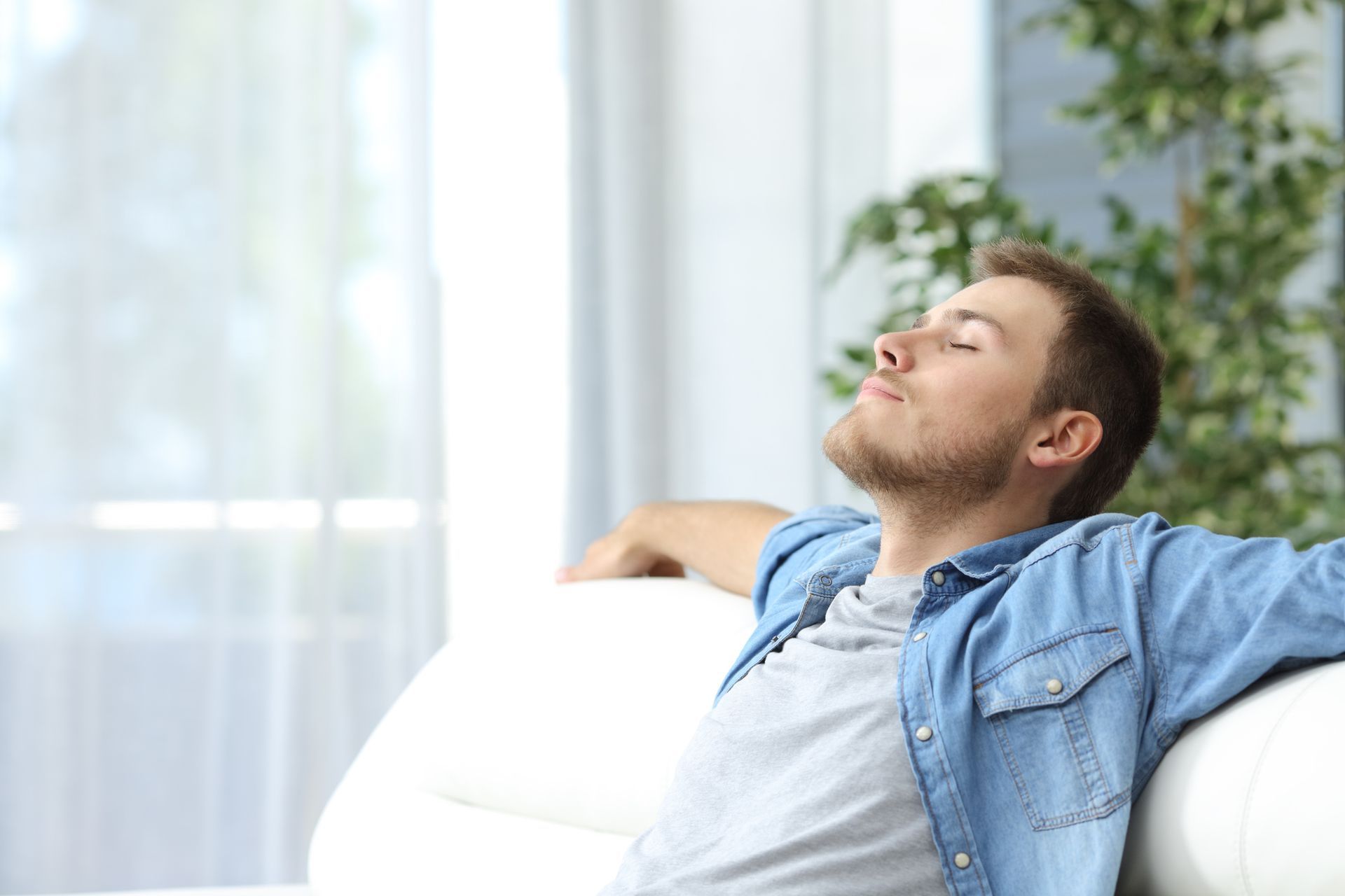 Man resting on a couch at home - Tallahassee, FL - Todd King's Heating and Cooling Man resting on a couch at home - Tallahassee, FL - Todd King's Heating and Cooling