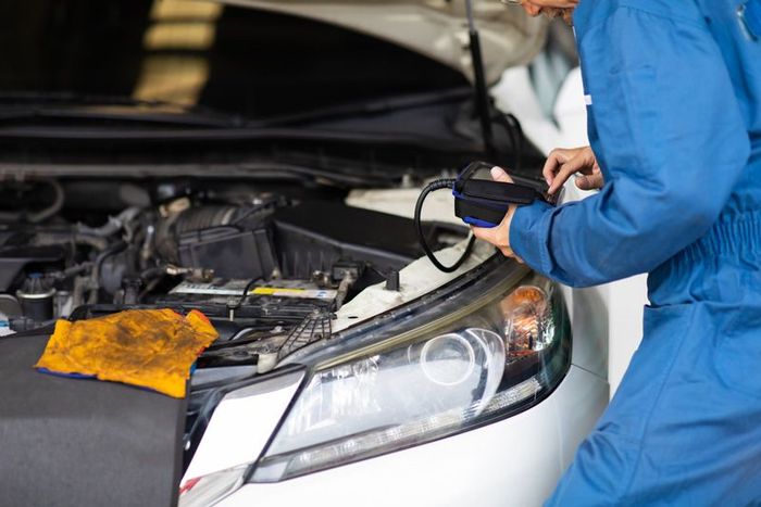 A Mechanic Is Working On A Car In A Garage — APPS Mechanical Port Macquarie In Port Macquarie, NSW