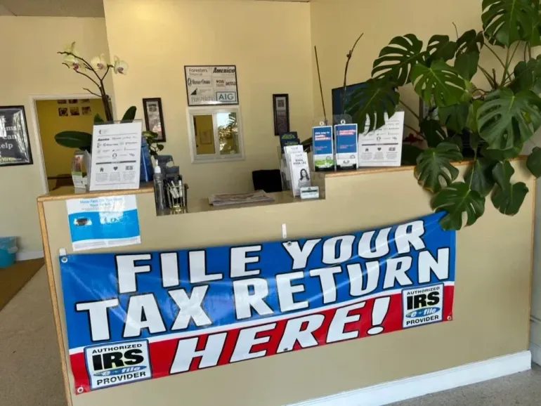 Tax office counter with sign reading “File Your Tax Return Here” and IRS logos