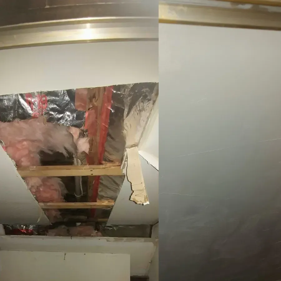 Damaged ceiling with exposed insulation, wooden beams, and hanging drywall panels in a room