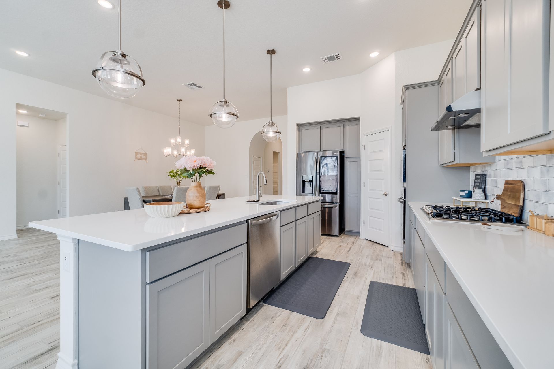 Elegant kitchen design with white cabinets & gray appliances, perfect for a kitchen remodel project.