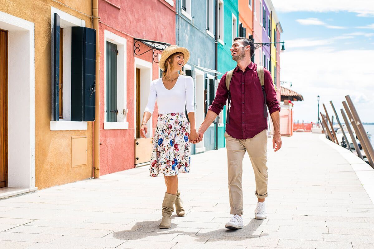 Couple walking through colorful Burano